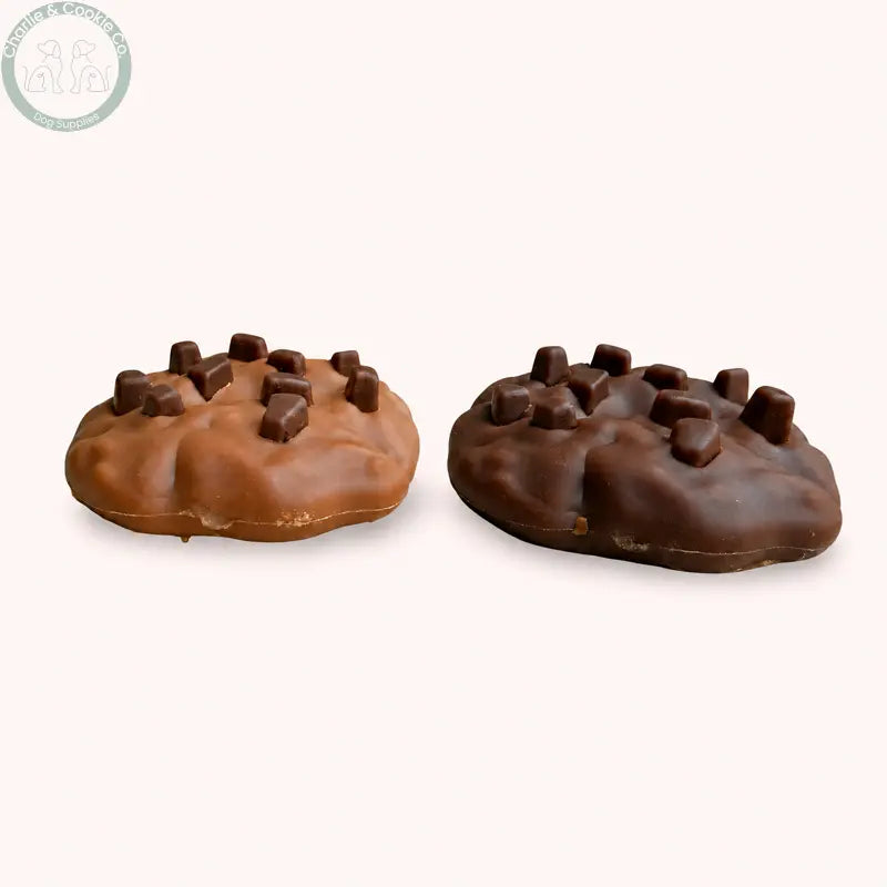 Maks Patch 7cm Carob and Peanut Butter dog cookies on a soft blush background