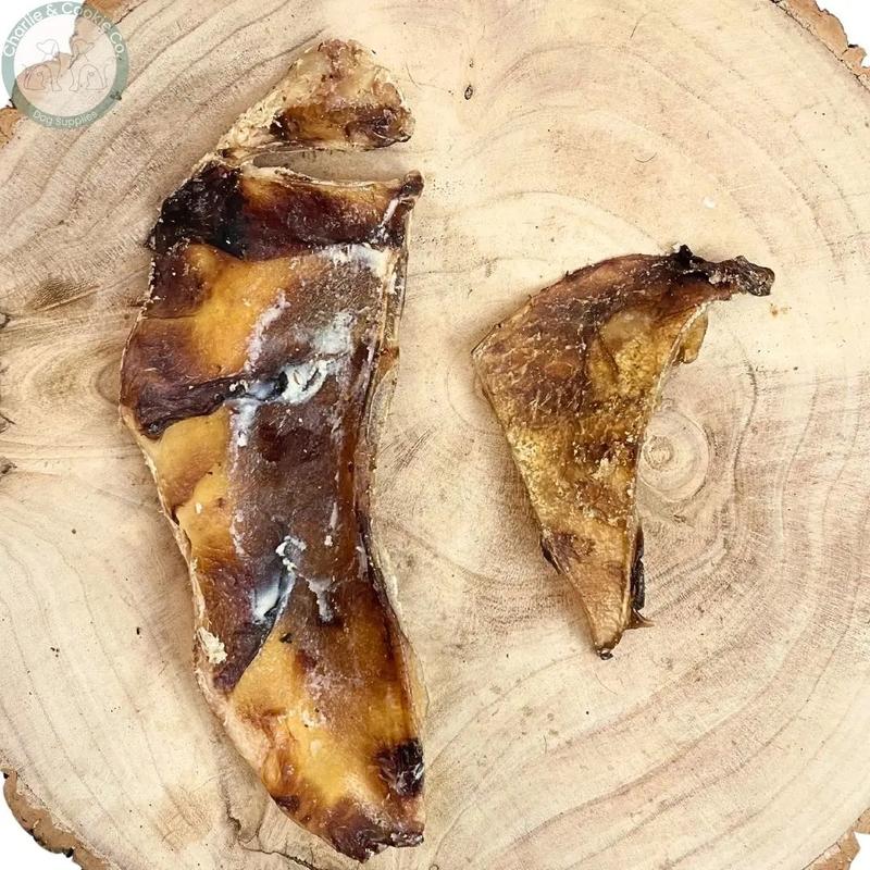 Paddock Farm Beef Moon Bones 1kg, two beef cartilage pieces on a wooden slice