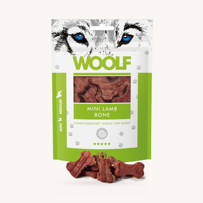 Woolf Mini Lamb Bone soft treats beside the 100g pack